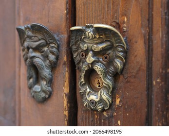 Keyhole Cover In The Shape Of A Bearded Man's Face. Two Similar But Not Identical Faces, In One There Are Screws Instead Of Eyes.