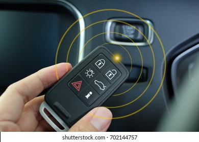 Keyless Entry System For Car, Smart Key In Hand With Frequency Effect.