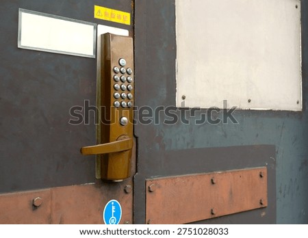 Keyless entry system with a numeric keypad symbolizes safety, privacy, and technology. Above the numeric keypad is a "locked" indicator plate.