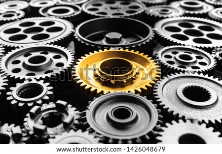 Keyman,key success or leadership concepts with metal gold cog outstanding in another cogs.Business performance.teamwork of human.
