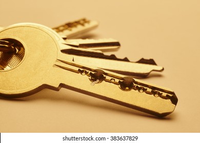 Keyring with keys in golden tone over an empty background. Horizontal - Powered by Shutterstock