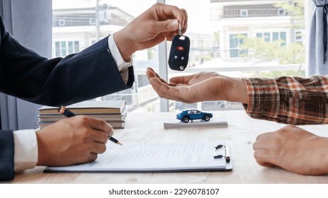 Keys and the car behind. Sell and buy a car. - Shutterstock ID 2296078107