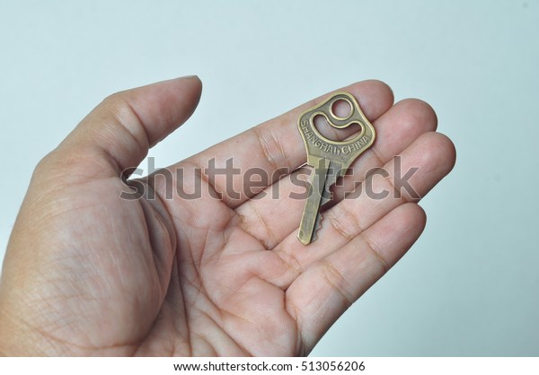 Keys in hand isolated on\
white