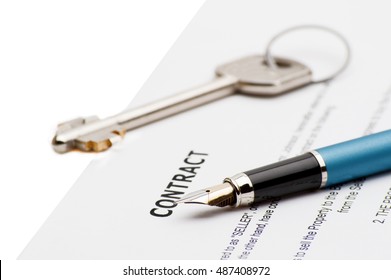 Keys of a new house and pen on contract. 