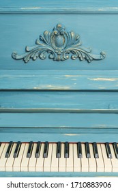 Keys of an old piano. Details of the design of the recolored blue and gold piano. Stucco on the piano