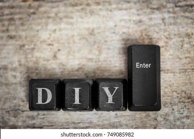 keys on a wooden table with the word diy, concept do it yourself