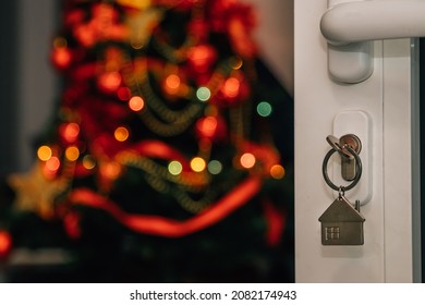 Keys In Open Door Lock With Christmas Tree Inside House