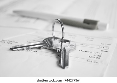 Keys and a pen on pile of documents/ Property purchase/ Property Insurance