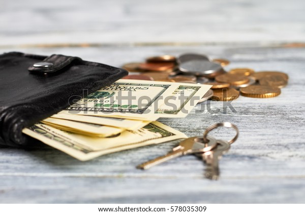 Keys and\
purse with money. Satisfaction with\
life.