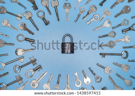 Keys set and lock concept, blue background. Protection of business and home, real estate security concept. Different antique and new keys.