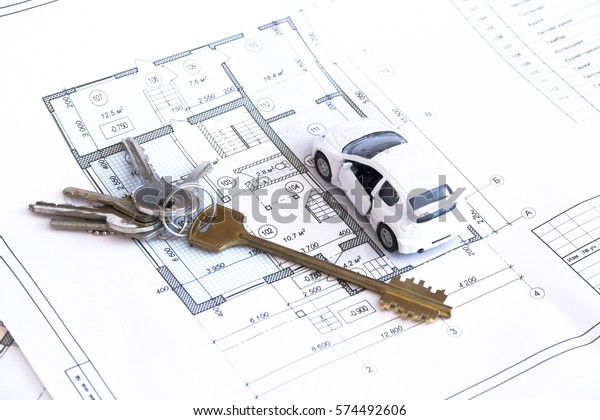 The keys\
and toy car on the plan apartment,\
cottage