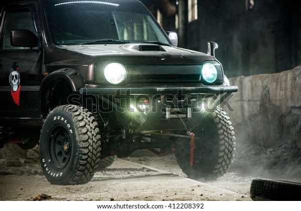 KHABAROVSK RUSSIA - April 20,\
2016 : off-road  Suzuki Jimny is in a large hangar with the lights\
on 