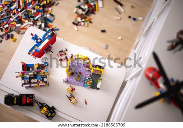 Khabarovsk, Russia, August 05, 2022.  Sorting\
small multicolored Lego Classic and Duplo pieces by colors top\
view. Modern childish constructor for playing toy educational\
development cars and\
planes