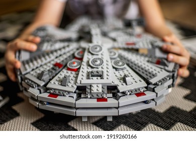 Khabarovsk, Russia, Janyary 10, 2021. The Child Shows The Spaceship From The Movie Star Wars. Big Lego Set. The Boy Shows The Spaceship From The Lego Millennium Falcon. From The Movie Star Wars.