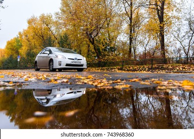 KHABAROVSK, RUSSIA - OCTOBER 14, 2017: White Toyota Prius On Autumn Road In Rainy Day