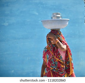 KHAJURAHO, INDIA 23 FEBRUARY 2018 : Unidentified Rural Indian Women Walking To Farm For Work With Basket On Her Heads, Daily Lifestyle In Rural Area In India.