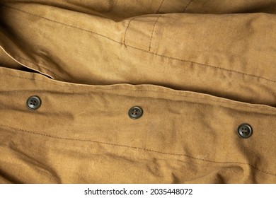 Khaki background, canvas cloth military jacket with buttons