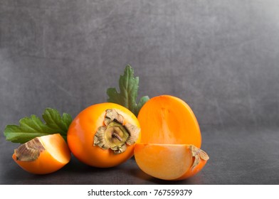 Khaki Fruit On A Grey Stone Background