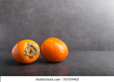 Khaki Fruit On A Grey Stone Background