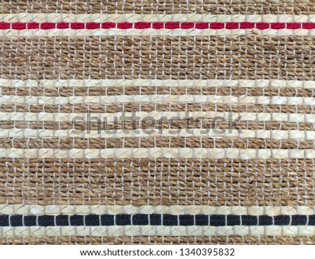 khaki weave burlap texture background with red; blue cotton rope decoration