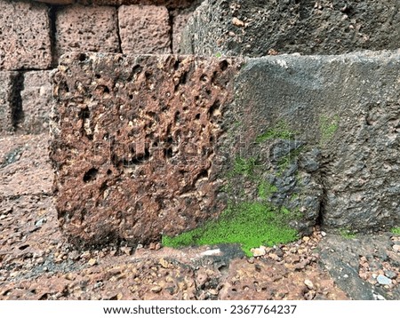 The Khao Klang Nok stone wall has green moss. Khao Khlang Nok is an ancient site of Si Thep Historical Park. Phetchabun Province and has become Thailand's seventh World Heritage Site.