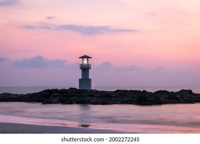 Khao Lak beach with light beacon or lighthouse for navigation during twilight, famous travel destination and resort near Phuket, Phang-Nga, Thailand