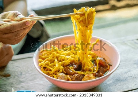 Khao Soi,Khao Soi Kai, Thai Noodles Khao Soi, Chicken Curry 
with seasoning on wooden floor, Northern Thai food concept. (Lanna food)