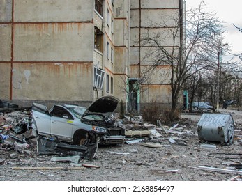 Kharkiv, Kharkov, Ukraine - 05.28.2022: crashed burnt car vehicle transport heap of mental wreckage in civil courtyard residential destroyed building consequences of russian terror war against Ukraine