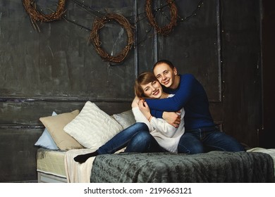 Kharkiv, Ukraine. 01.23.2017. Portrait Of Happy Young Couple, Family. Beautiful Woman, Handsome Man Relaxing In Modern Bedroom In Bed, Kissing, Smiling. Family Holiday,  Togetherness, Date.