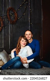 Kharkiv, Ukraine. 01.23.2017. Portrait Of Happy Young Couple, Family. Beautiful Woman, Handsome Man Relaxing In Modern Bedroom In Bed, Kissing, Smiling. Family Holiday,  Togetherness, Date.