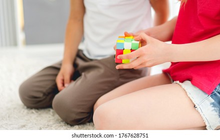 Kharkiv, Ukraine - 06 June 2020: Colorful rubik's cube puzzle in kids hands, close up view