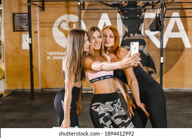 Kharkiv, Ukraine 06.01.21 Three Girls Stand Together In The Gym Taking Selfie On The Phone