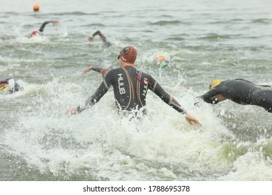 Kharkiv, Ukraine - August 02, 2020: Triathlon. People In Wetsuit Swimming. Competitors Swimming Out Into Open Water At The Beginning Of Triathlon.