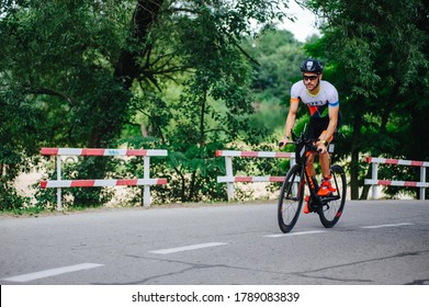 KHARKIV, UKRAINE - August 2, 2020: Triathon Biking Cyclist Triathlete Riding Bike During Ironman Competition. Road Athlete In Tri Suit And Helmet. Public Events Are Allowed. Europe Sport Durin