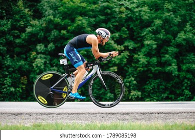 KHARKIV, UKRAINE - August 2, 2020: Triathon Biking Cyclist Triathlete Riding Racing Bike During Ironman Competition. Road Cycling Athlete In Tri Suit And Helmet. Public Events Are Allowed. 