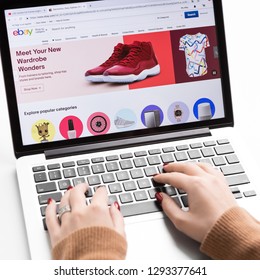 Kharkiv, Ukraine - December 11, 2018: Ebay official website on MacBook computer screen, woman buying through online auction and sales website