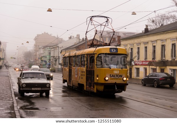 Kharkiv, Ukraine -\
December 31, 2017 Kharkov tram People getting on to a red tram at\
Kharkiv Ukraine in day\
time.