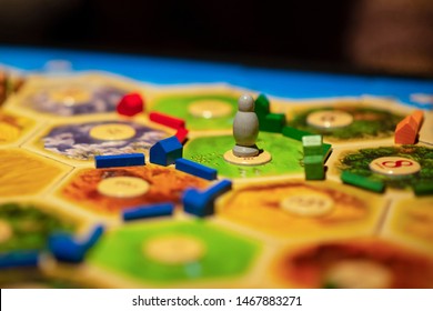 Kharkiv, Ukraine - Jan 05 2018: The Settlers Of Catan, Ongoing Multiplayer Board Game. Settlements And Robber Focused