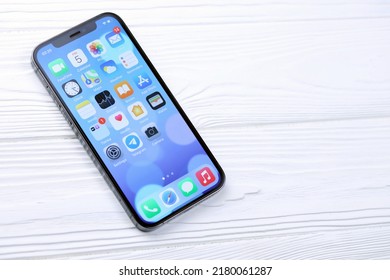 KHARKIV, UKRAINE - JANUARY 27, 2021: Apple Iphone 12 pro new brand model smartphone with IOS base on white background. Apple Inc. is an American technology company headquartered in California
