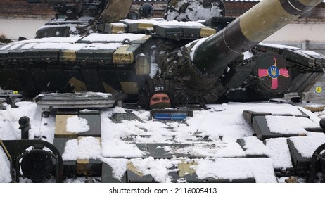 Kharkiv, Ukraine - January, 31, 2022: A tanker peeps out of the hatch of a T-64 tank. The Ukrainian army is preparing to defend itself against the invasion of Russia