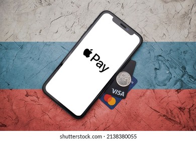 Kharkiv, Ukraine - March 13, 2022 : russian sanctions, apple pay sanctions in russia, apple pay leaving the russian market, iphone with apple pay logo and visa and master card cards