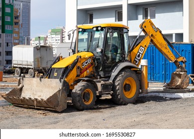 Kharkiv, Ukraine, March 29, 2020: The dirty yellow JCB tractor at the construction site. Illustrative editorial.