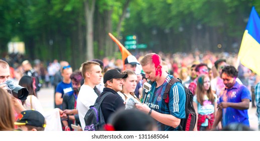 Kharkiv, Ukraine - May 19, 2018: Crowd of people celebrating Holi festival of colors in the cenral park of the town