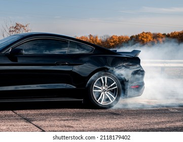 Kharkiv, Ukraine - October 2021: Muscle Car Ford Mustang Doing A Burnout. Side View