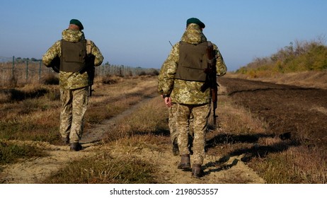 Kharkiv, Ukraine - Oktober, 01, 2021: Ukrainian Border Guards Walk Along The State Border Of Ukraine With Weapons And A Dog. Border Guard Soldiers Guard The State Border Between Ukraine And Russia