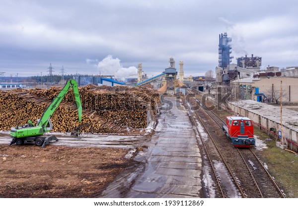 Kharkiv, Ukraine -
Spring 2021: A small, bright red TGM40 private diesel locomotive
stands on the grounds of a woodworking plant Swiss (Swiss Krono). 
Drone aerial view