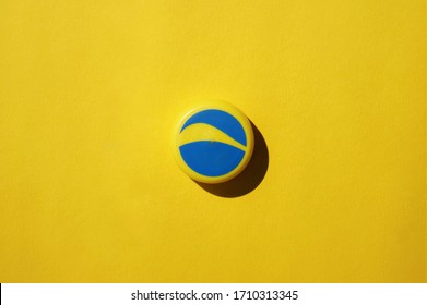 KHARKOV, UKRAINE - APRIL 21, 2020 : Yellow-blue plastic cap from under the Pepsi cola on a yellow background.