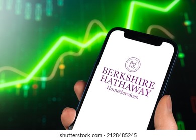 Kharkov, Ukraine - February 11, 2022: Berkshire Hathaway logo, stock trade on green chart. Business and finance market background photo