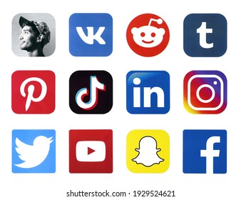 KHARKOV, UKRAINE - FEBRUARY 24, 2021: Many icons of popular social networks and messengers printed on white paper. Logos of modern communication portals and smartphone apps.