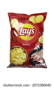 KHARKOV, UKRAINE - JANUARY 3, 2021: Lays potato chips with bacon flavour and original lays logo in middle of package. Worldwide famous brand of potato crisps